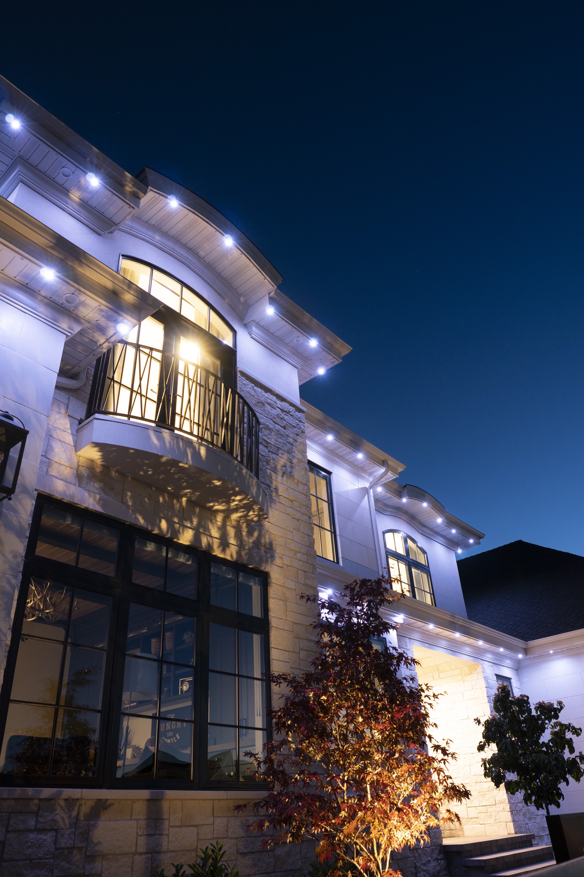 Home with permanent outdoor lighting at night